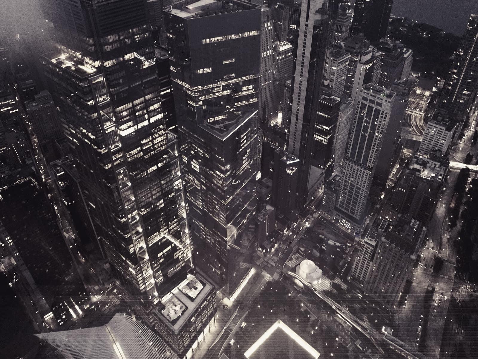 Lit office towers seen from above at night