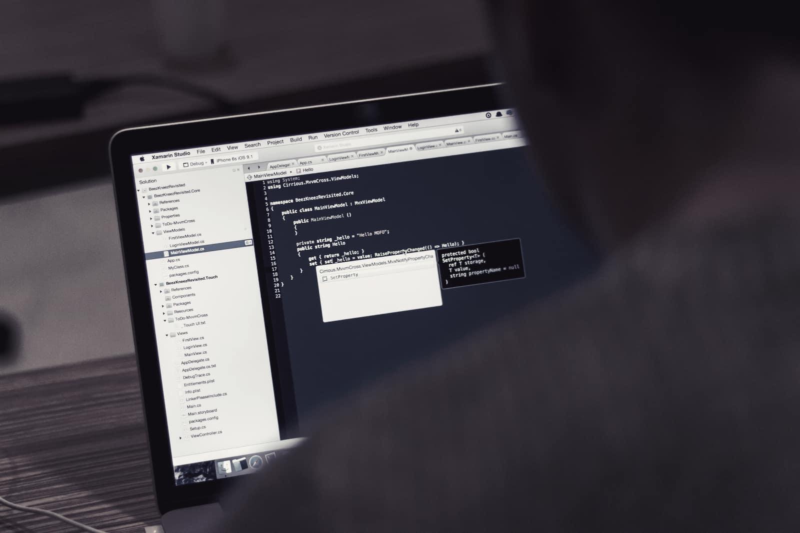 A developer writing software on a laptop