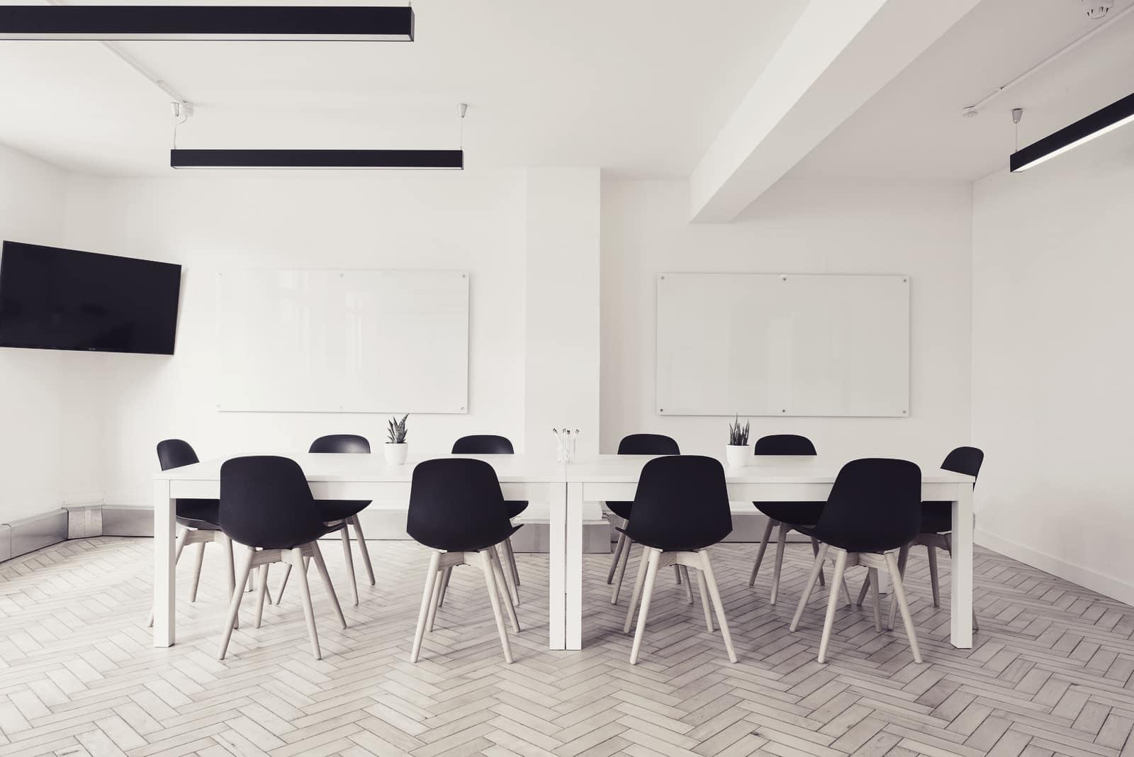 An empty, bright conference room with a long table
