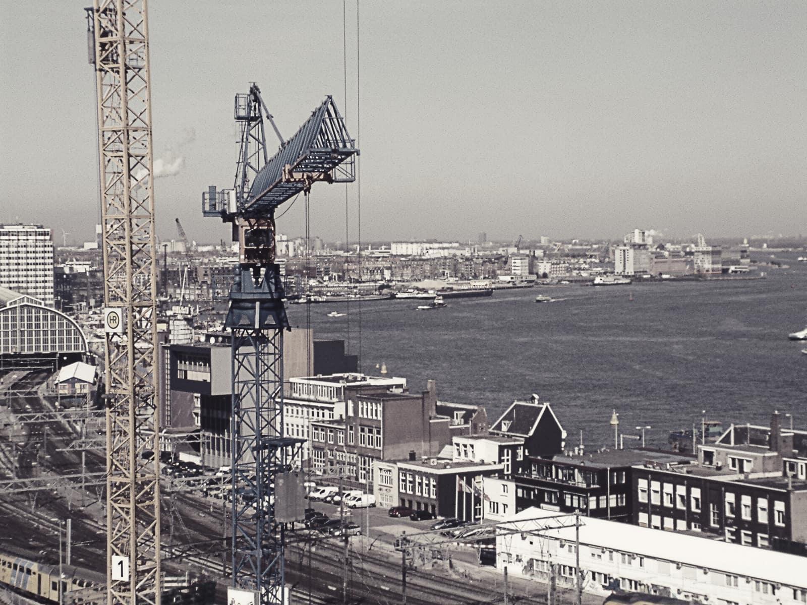Tower cranes over a waterfront construction site