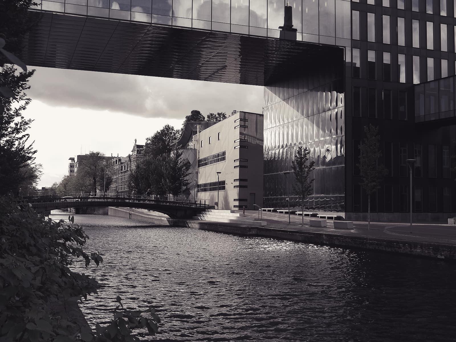 Glass office buildings reflected in a canal