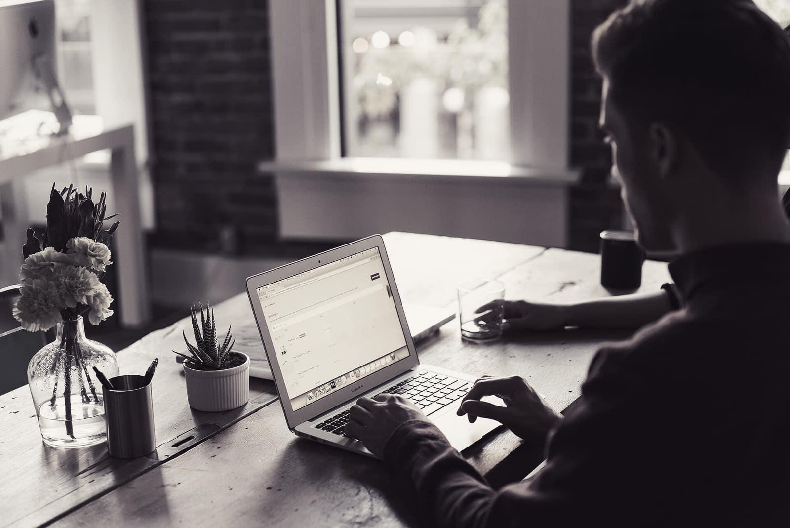 A person working at a laptop at an office desk
