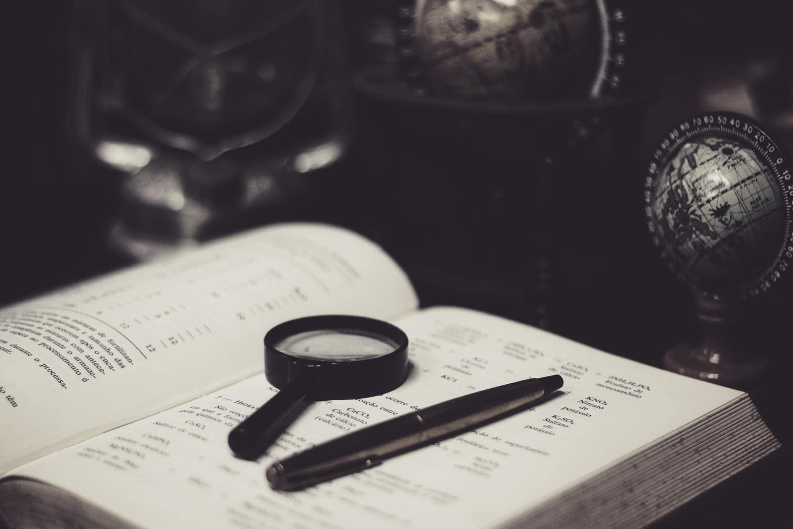 A magnifying glass resting on an open book