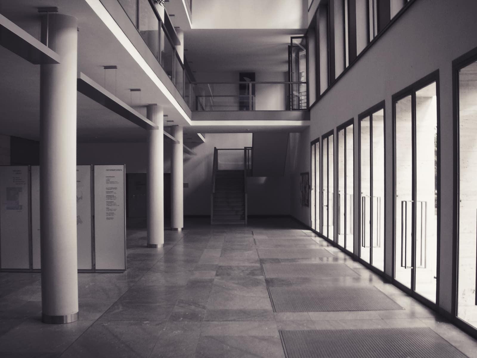 A long, quiet corridor in a modern office building