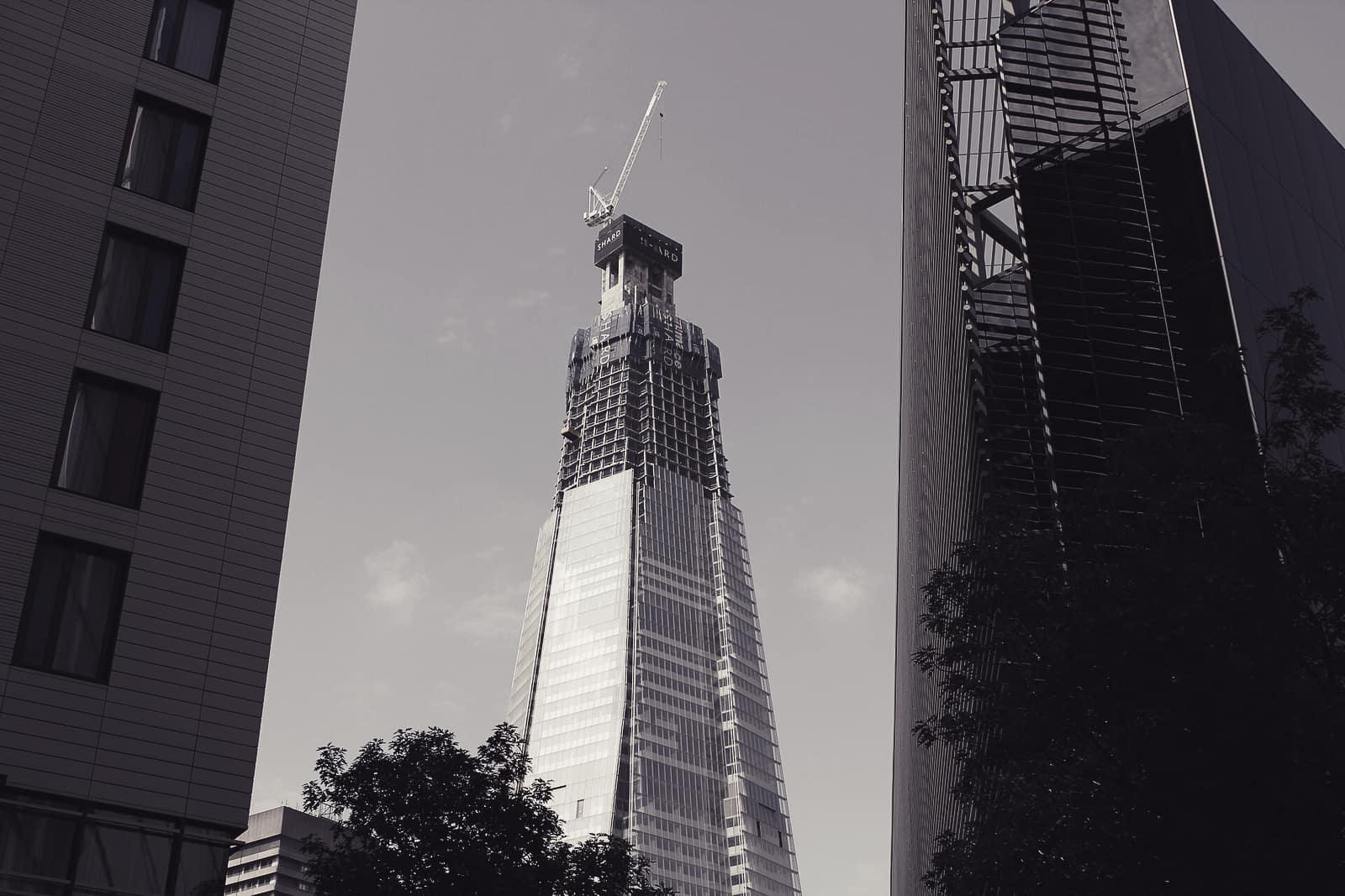 The Shard rising between glass office buildings near London Bridge